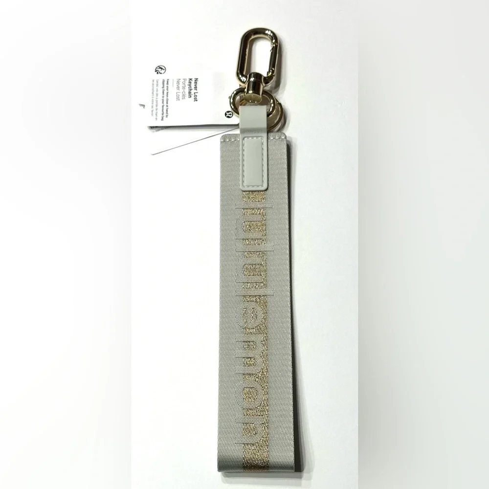 Lululemon Never Lost Keychain Wordmark Vapor Gold, NEW